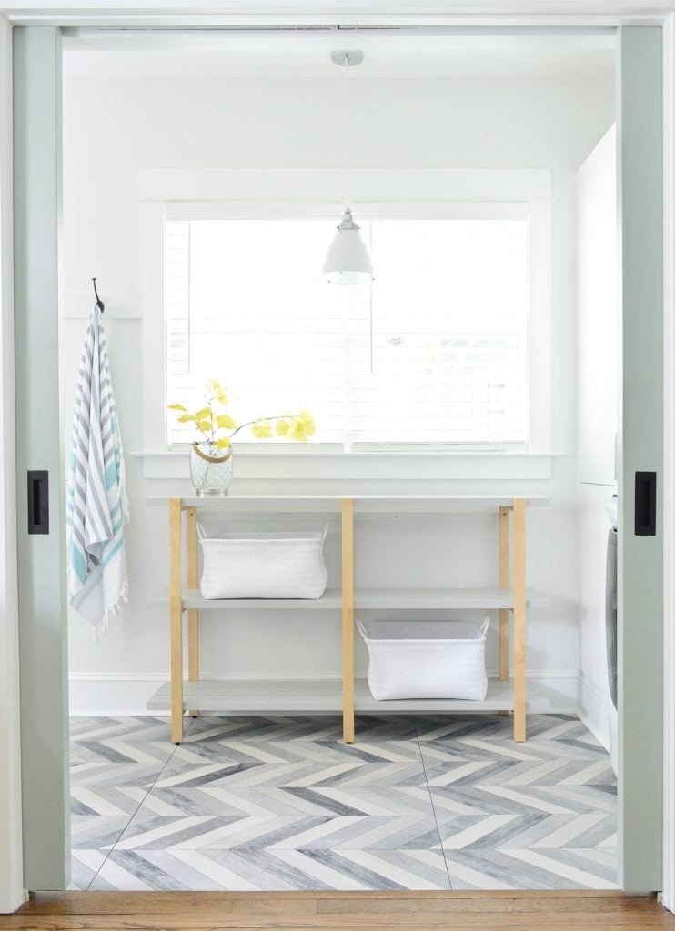 Open Shelf Through Pocket Doors In Duplex Mudroom Laundry