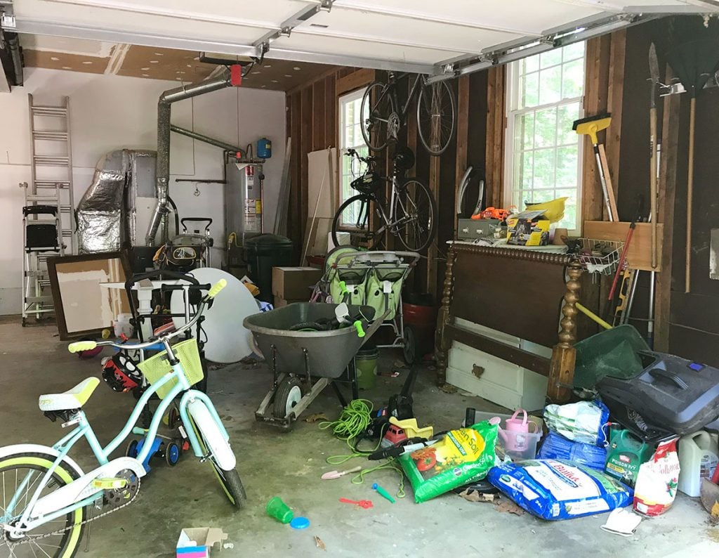 Messy garage with bike furniture and random outdoor supplies