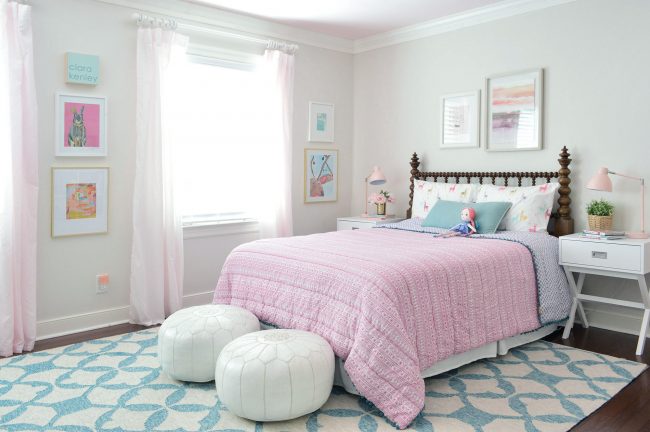Girl's Bedroom With Wood Spindle Bed And Blue Rug And Pink Bedding