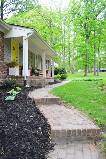 After Photo Of Landscaped Brick Pathway With Modern Chunky Posts On Front Porch