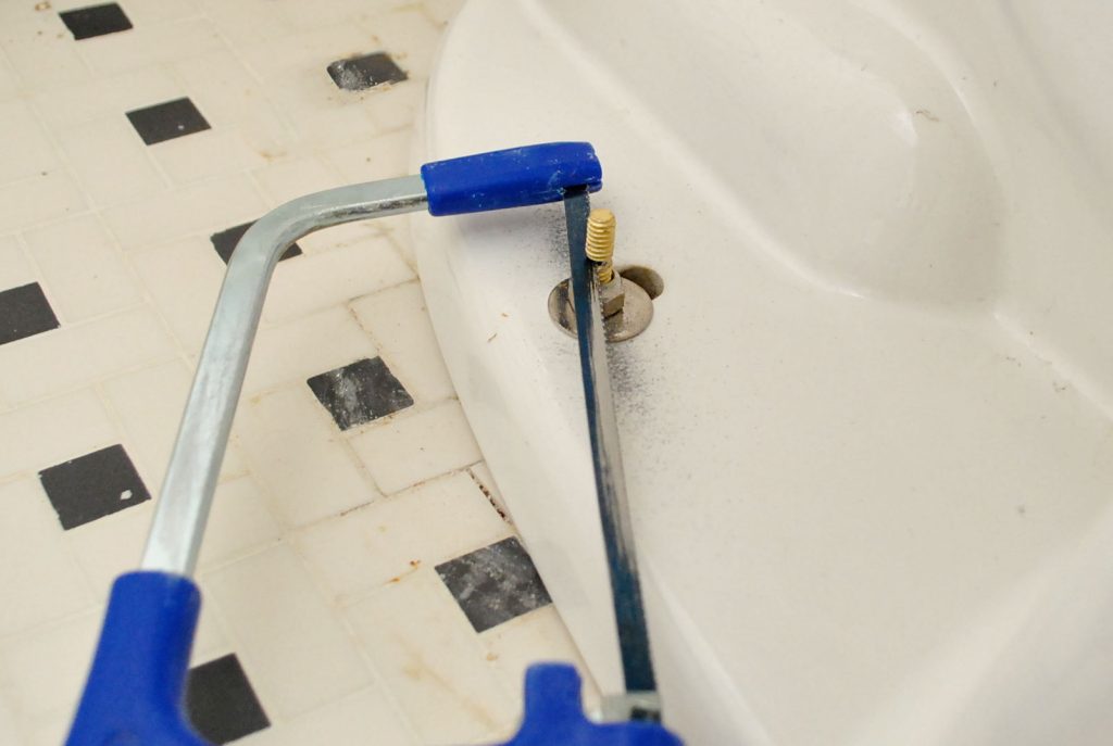 Hacksaw Removing Excess Bolt Length On New Toilet