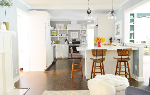 After Photo of Kitchen With White Cabinets Cork Floors and Gray Penny Tile Backsplash