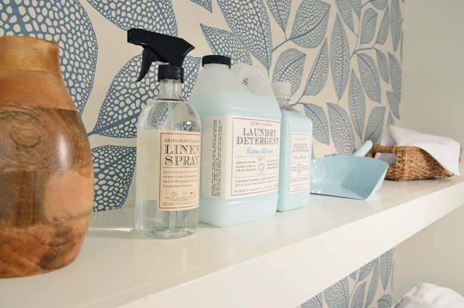 Floating White Shelf In Modern Laundry Room With Leafy Wallpaper