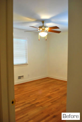 Before Photo Of Bedroom With Plain White Walls and Hardwood Floors